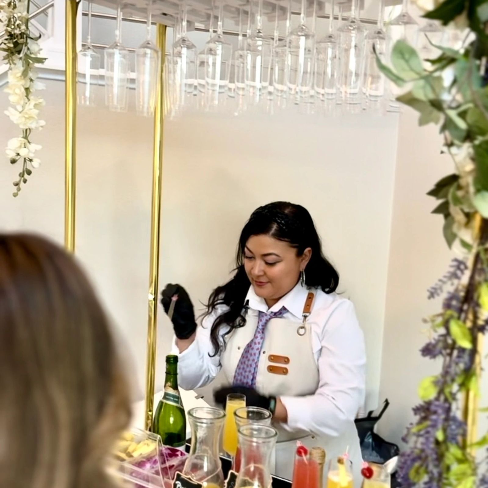 Bartender pouring sparkling wine for a guest at a private party