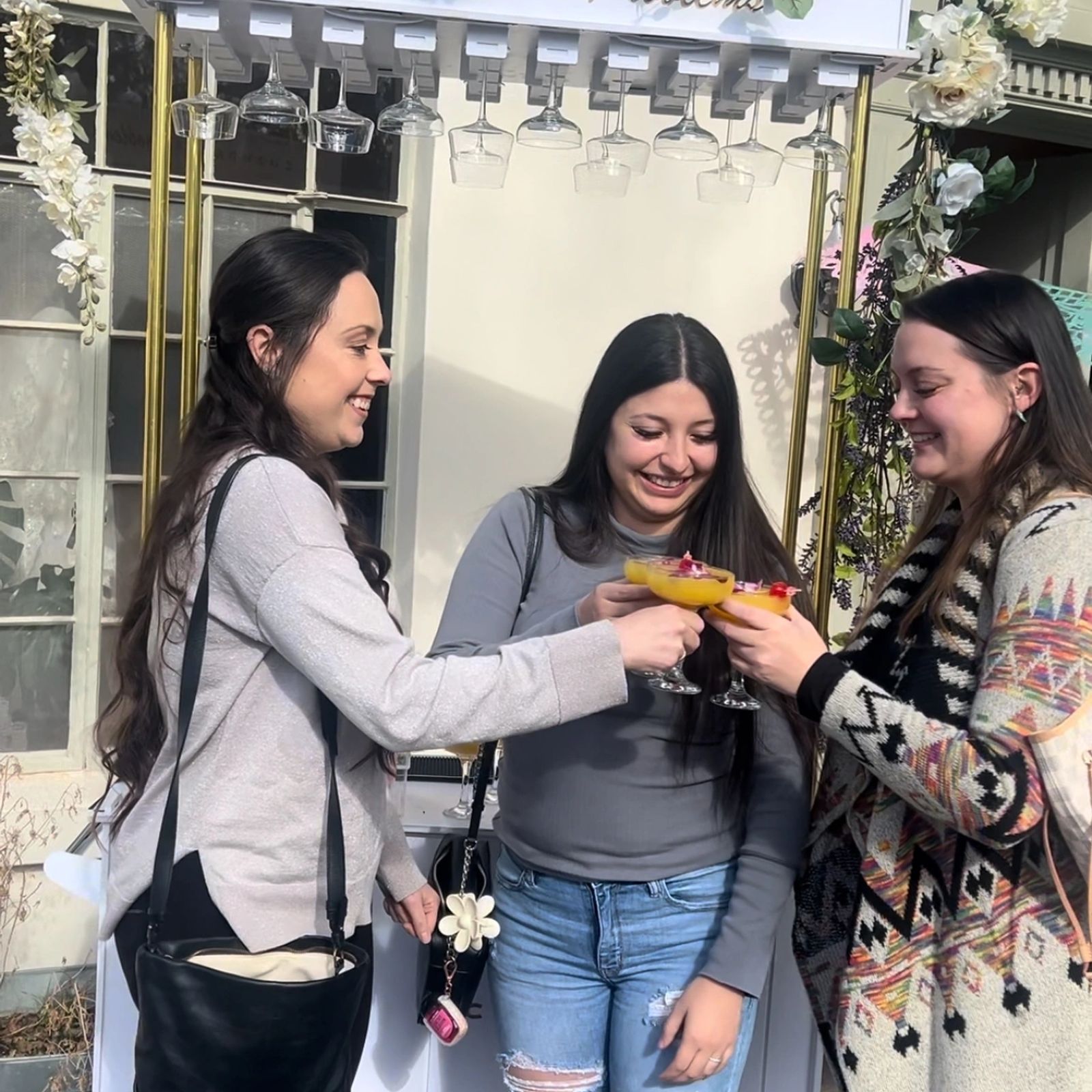 Guests toasting cocktails in front of the mobile bar
