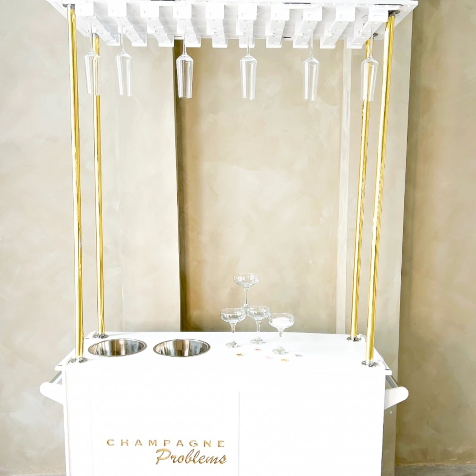 Champagne bar with chilling buckets and hanging flutes